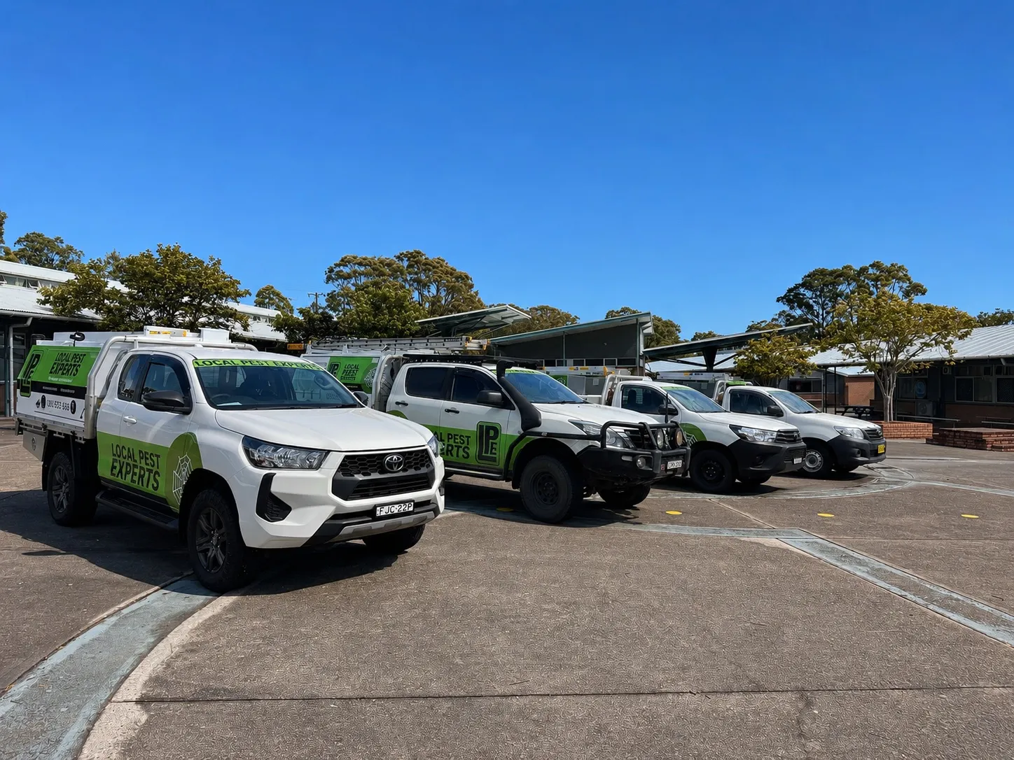 Four Local Pest Experts utes parked in a row