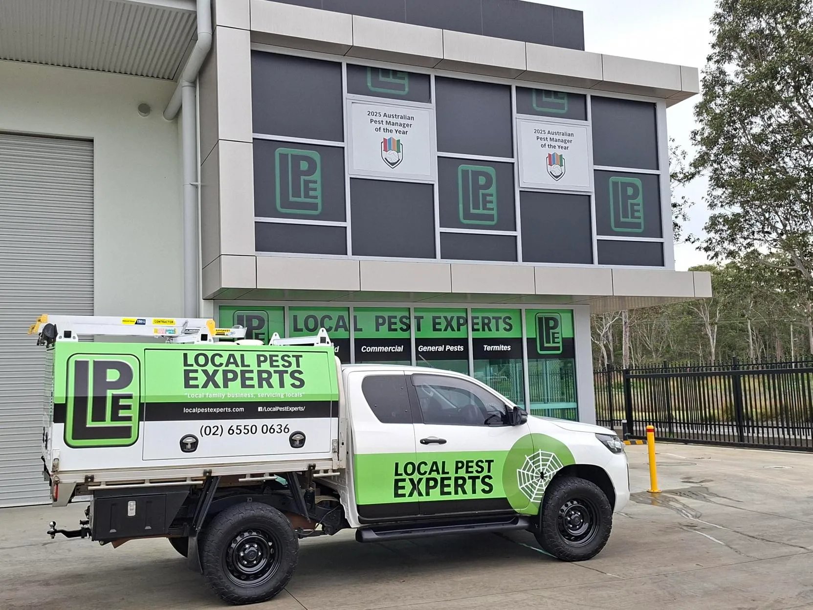 A Local Pest Experts ute outside the Taree office, with Pest Manager of the Year 2025 signs in the upstairs windows