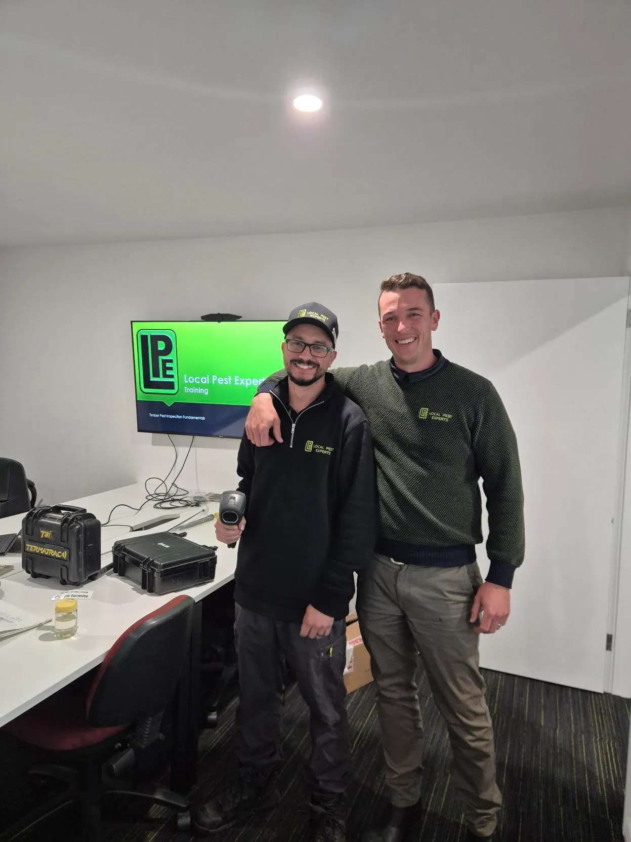 Two Local Pest Experts team members in the training room at the Taree office