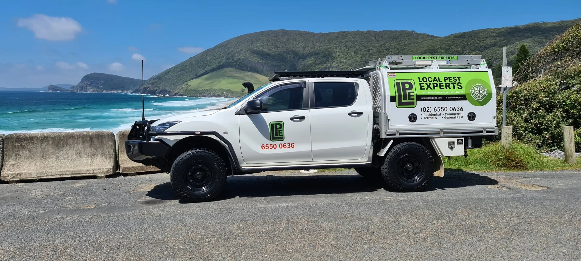 A Local Pest Experts ute at a coastal lookout near Pacific Palms